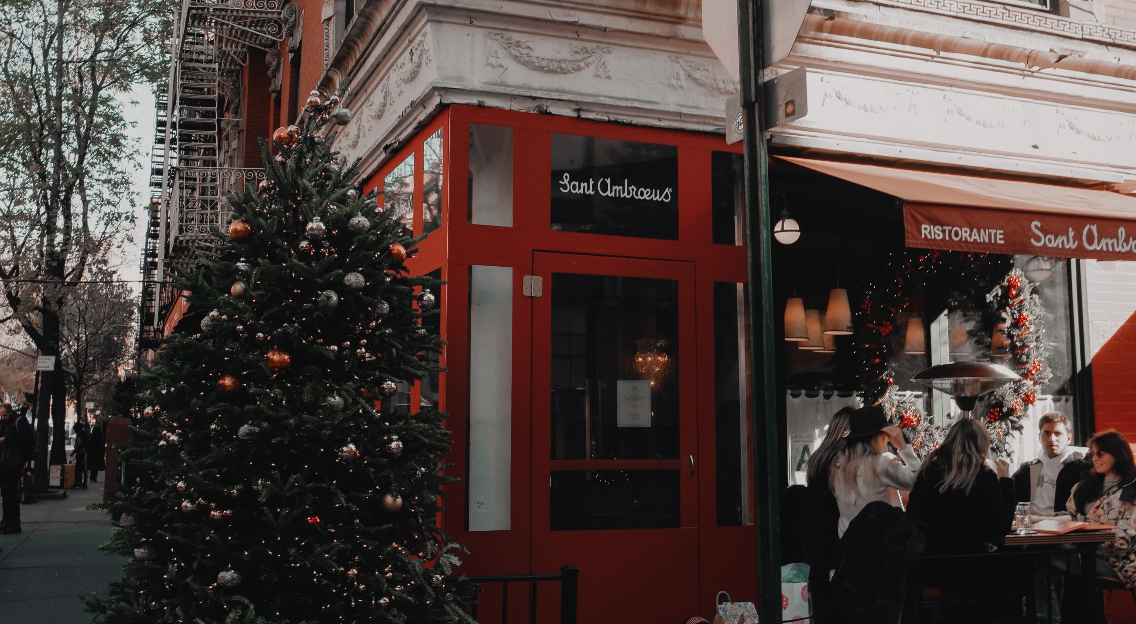 Red painted street corner with a Christmas tree