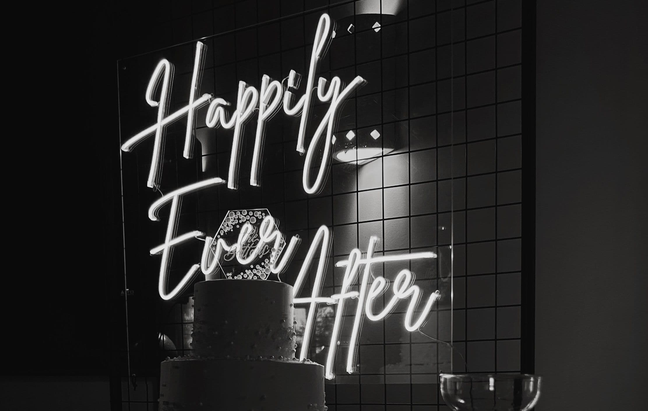Happily ever after neon sign with a wedding cake