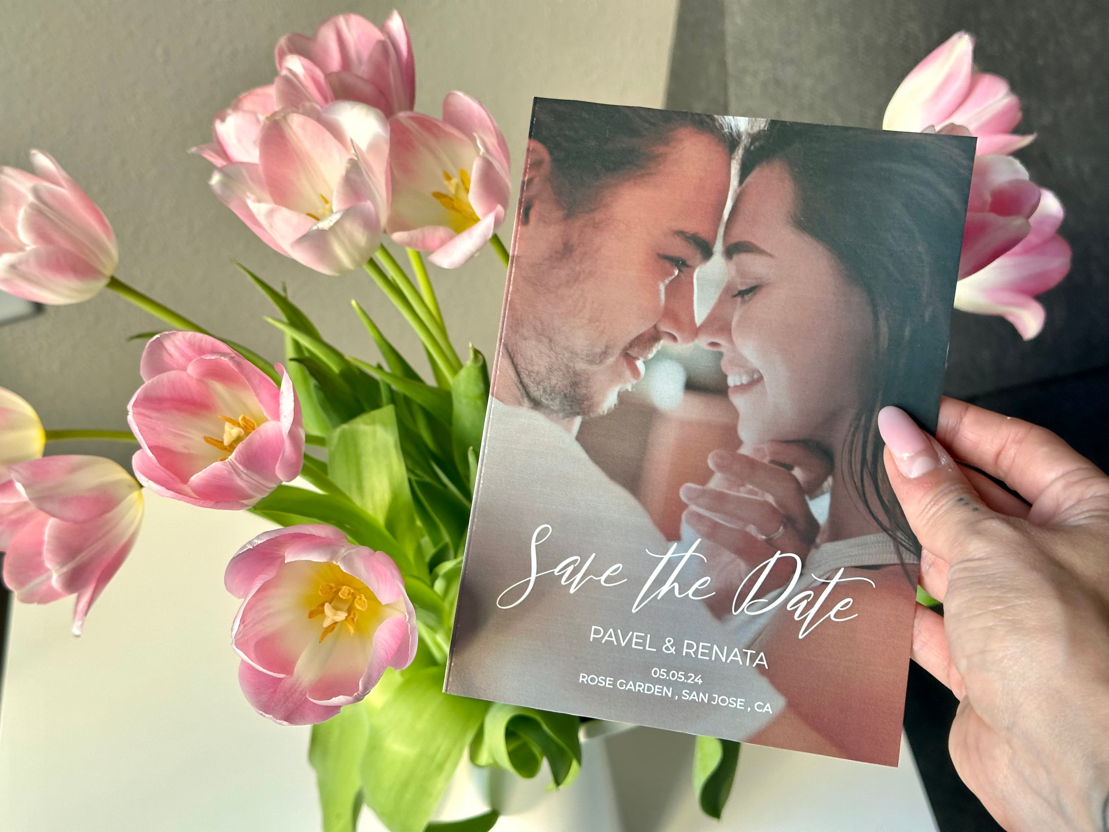 save the date card in front of a floral background