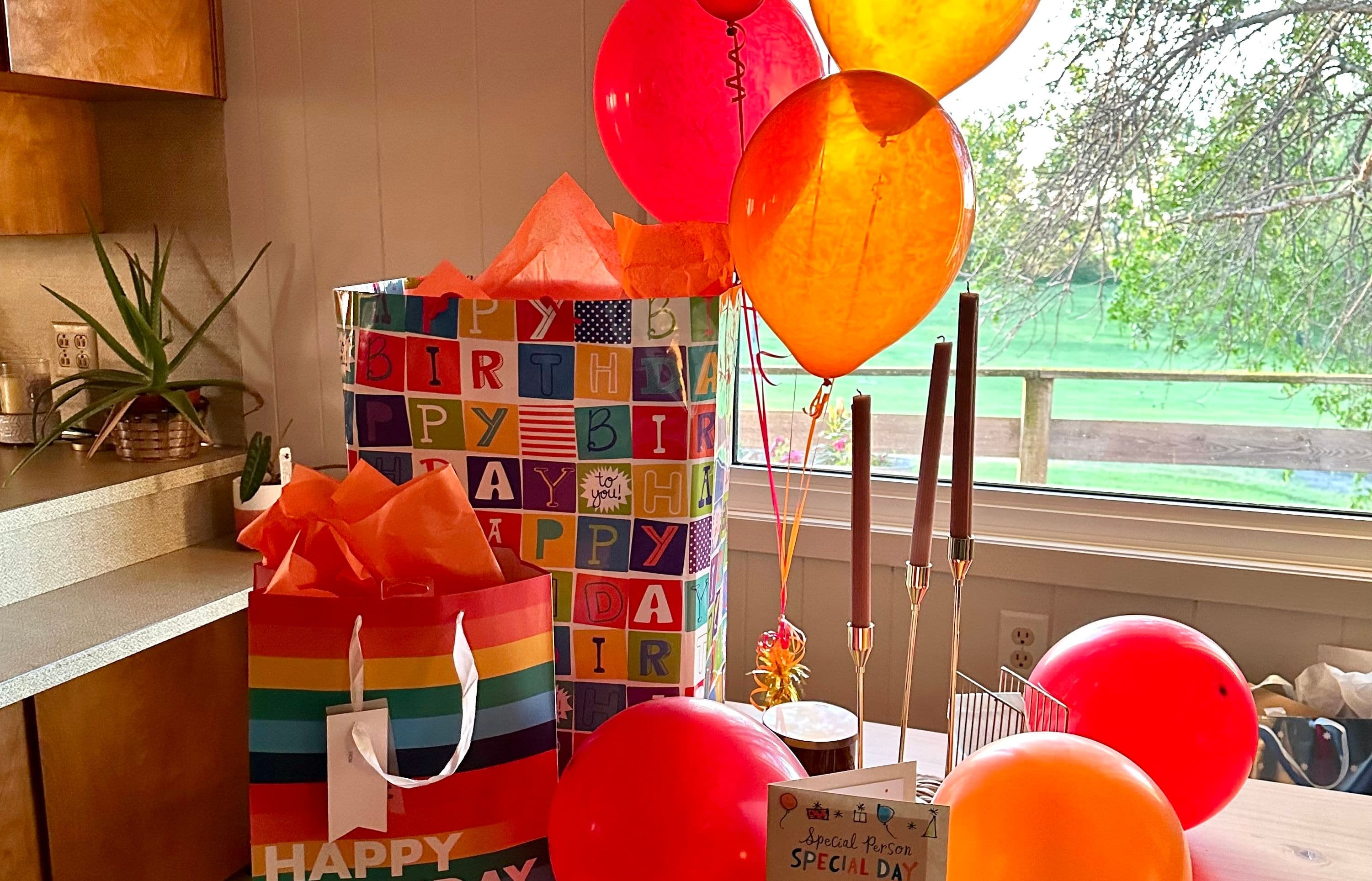 Colorful birthday gifts and balloons