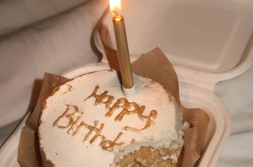 Little birthday cake with white frosting and a candle