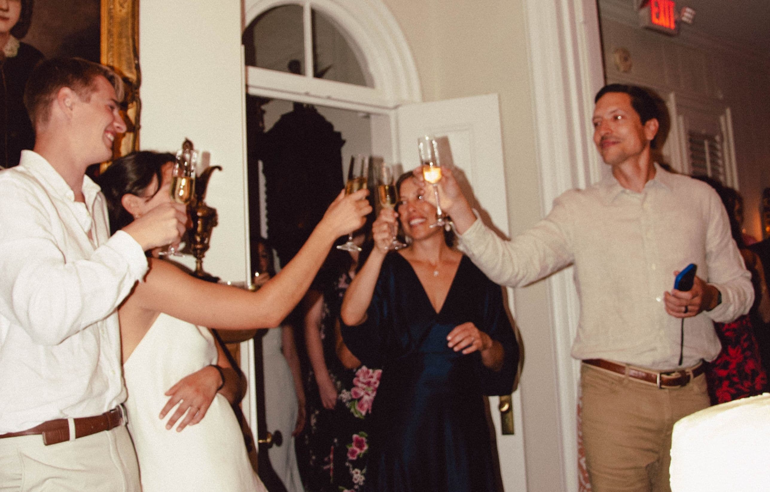 Wedding guests toasting with the bride and groom