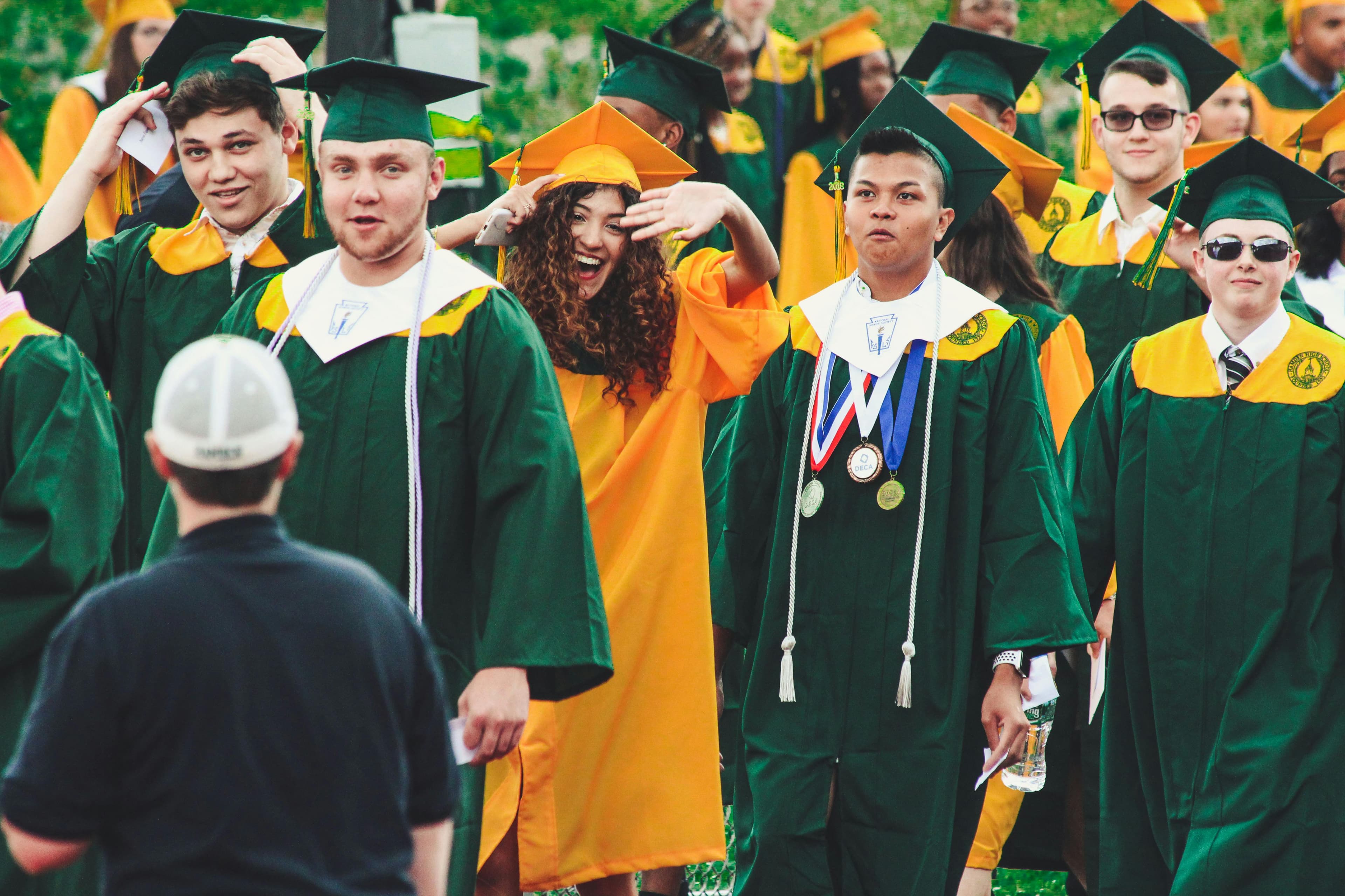 graduates crossing the stage
