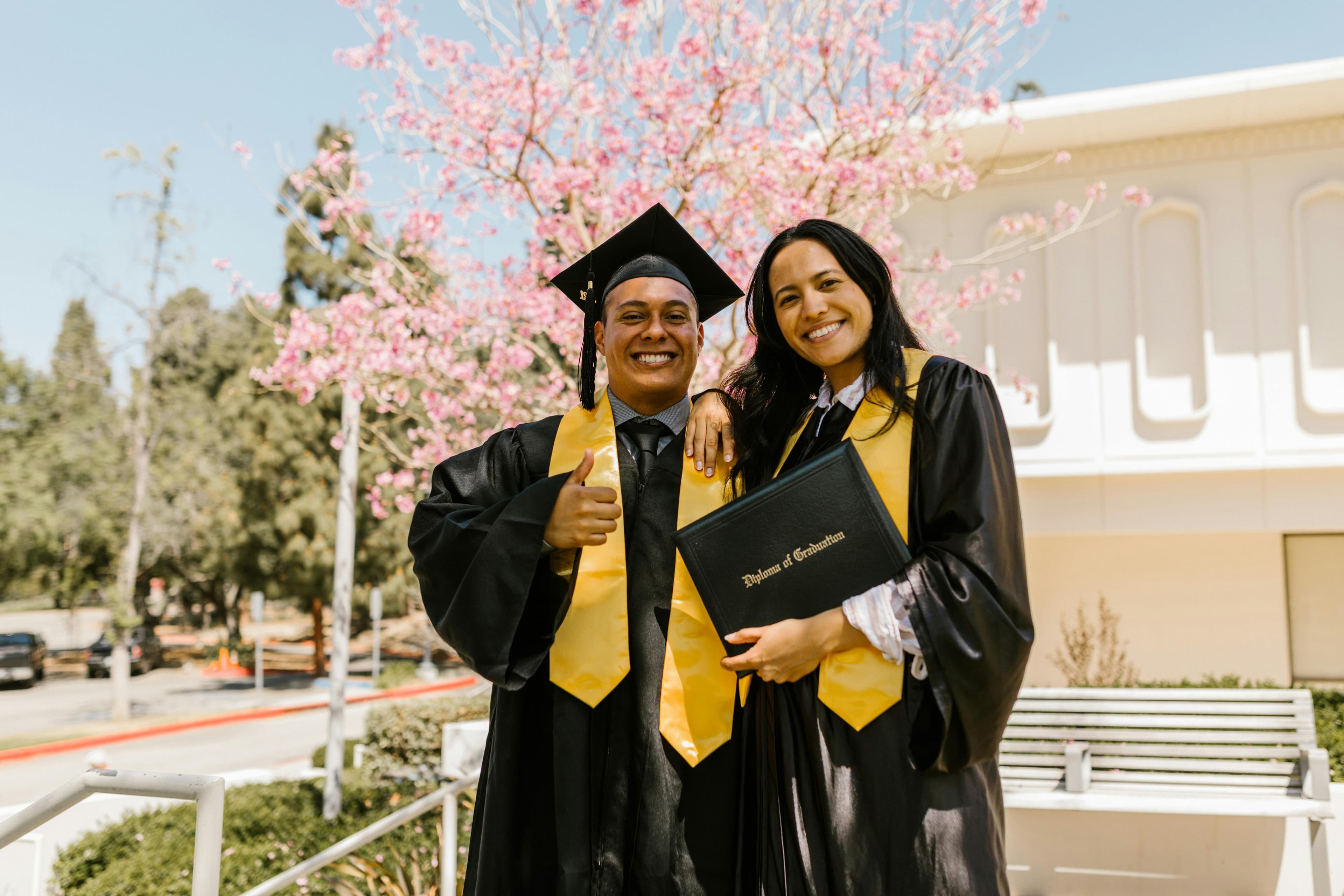 friends smiling during a graduation ceremony