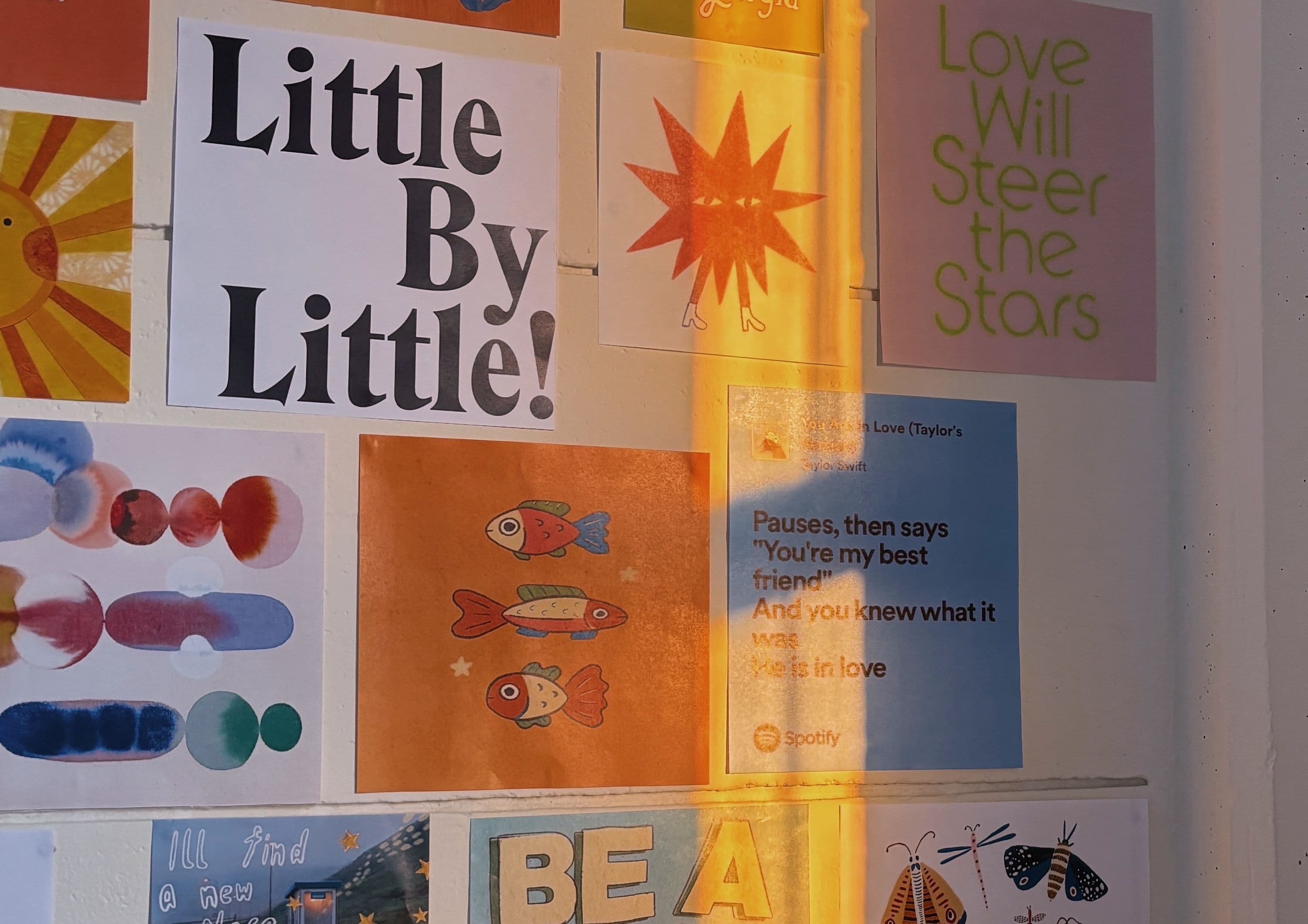 Posters on a wall with sunset light