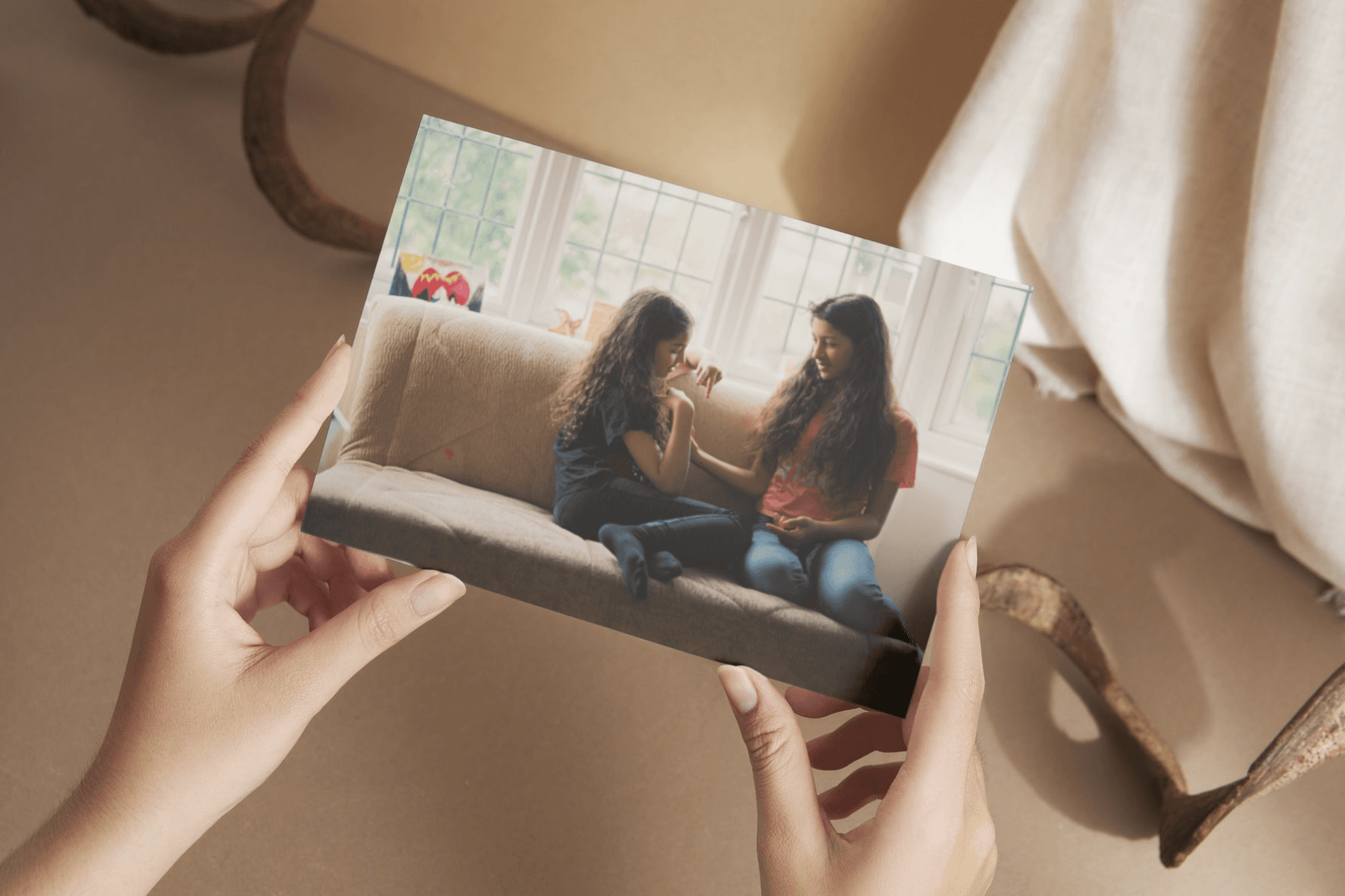 photo in hand of two sisters